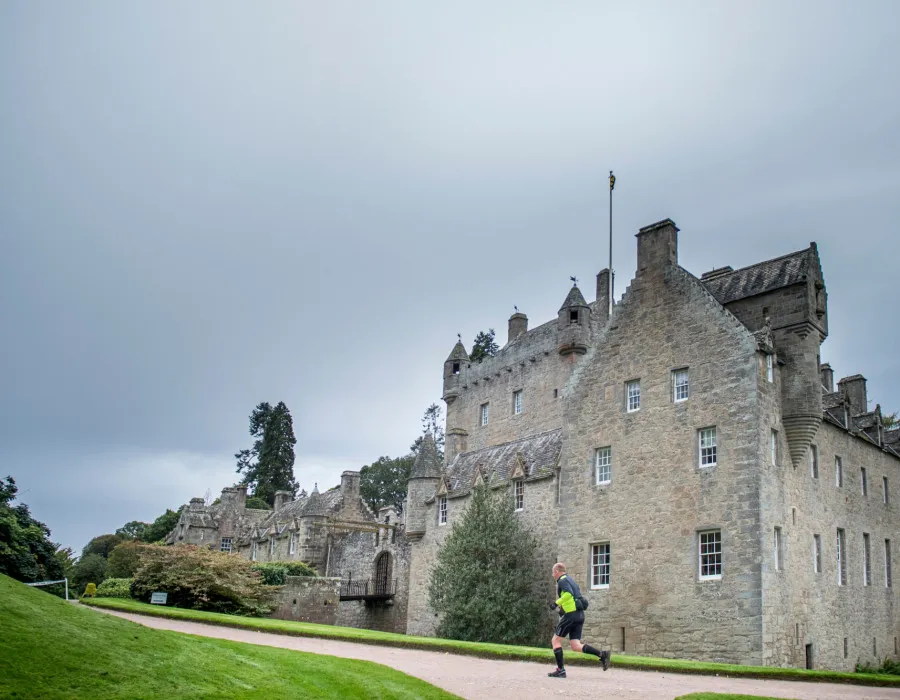 Man running past building