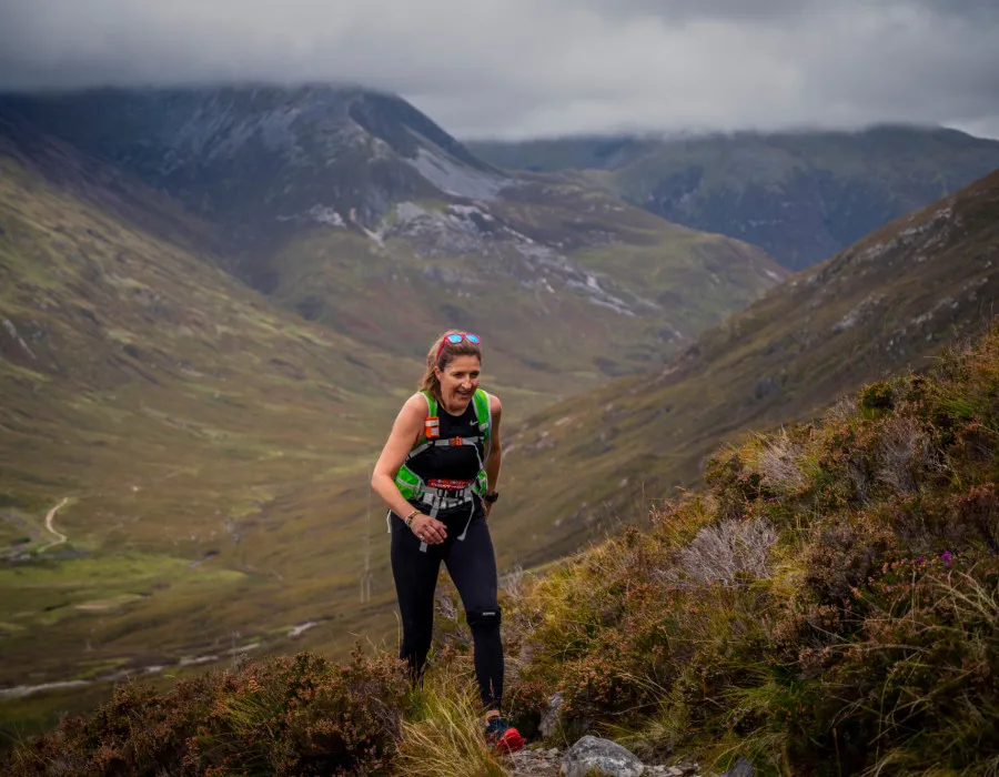 Woman running up mountain